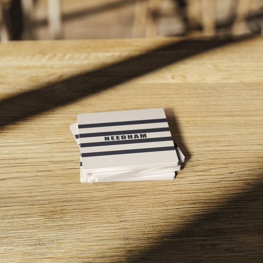 The_Namesake_Stone_Coasters_SquareStoneCoaster_WoodTable_AS_Mockup.png
